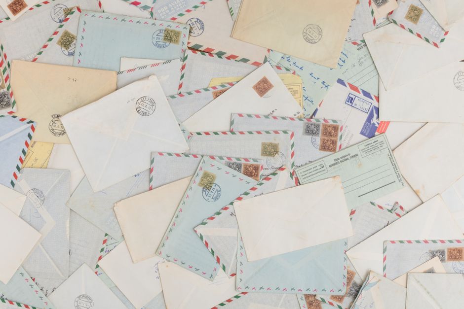 Scattered envelopes and postcards with postage signs