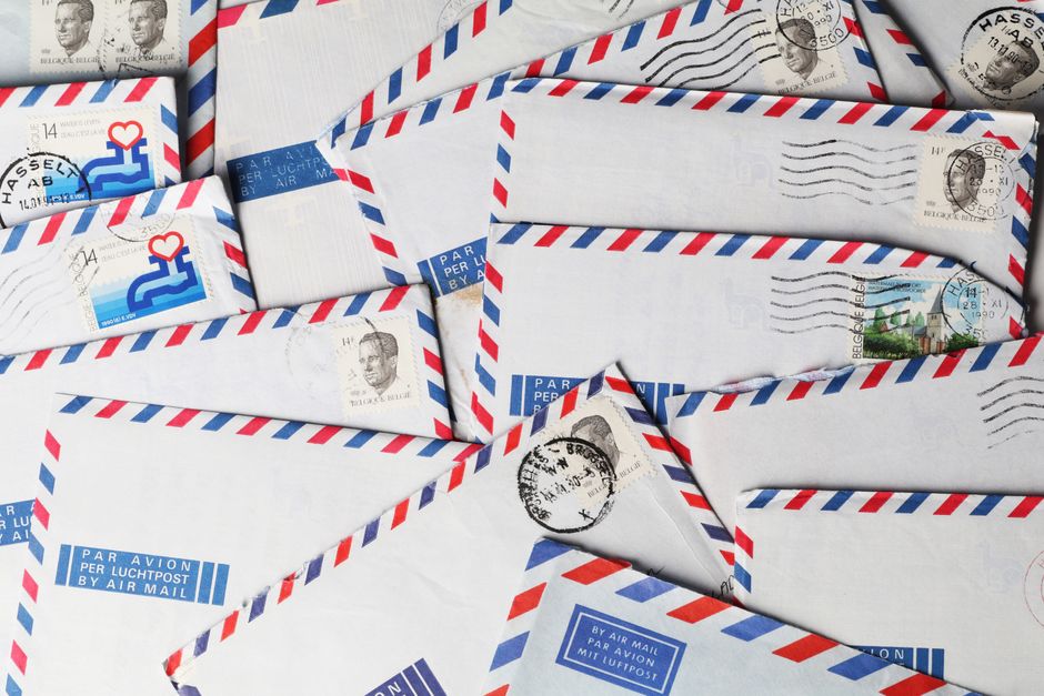 Stacks of airmail envelopes with stamps and postmarks